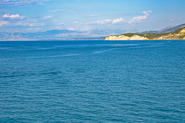 Naklejka premium Aerial view of green rocky cliffs in the ocean.