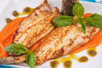  Sea fish steak with basil and green pepper on a pumpkin puree pillow according to the Georgian recipe. Mediterranean cuisine