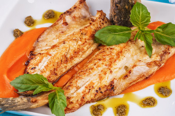  Sea fish steak with basil and green pepper on a pumpkin puree pillow according to the Georgian recipe. Mediterranean cuisine