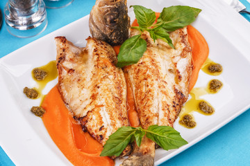  Sea fish steak with basil and green pepper on a pumpkin puree pillow according to the Georgian recipe. Mediterranean cuisine