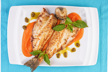  Sea fish steak with basil and green pepper on a pumpkin puree pillow according to the Georgian recipe. Mediterranean cuisine