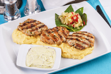  Fried fish patties served with vegetables, salad and greens and mashed potatoes according to Georgian recipe