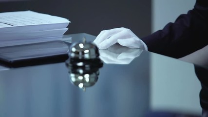 Female hotel visitor ringing bell on reception desk, high-quality resort, luxury - Powered by Adobe