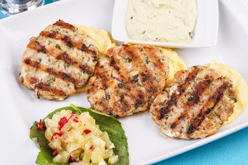  Fried fish patties served with vegetables, salad and greens and mashed potatoes according to Georgian recipe