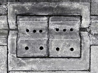 Concrete drainage holes, rectangular tubes, cloth and drainage holes on the concrete slabs to prevent flooding in the urban residential area On a cement floor background.v-shaped drainage gutters.