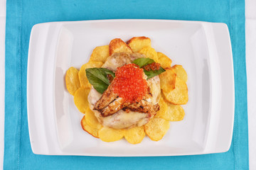 Seafood, Mediterranean cuisine, European dish. Sea salmon Fish steak with greens, country-style fried potatoes, cheese and cream sauce. Caucasian national cuisine