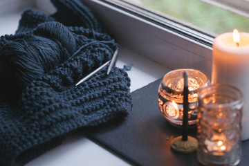 Candle and aroma stick on windowsill. Concept of relax, tranquil, peaceful, unplug, balanced time, Keep kalm and take it easy, knit leisure, meditation zen background