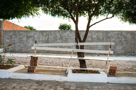 Poorly built wooden bench supported by bricks on a street in Oeiras, Piaui - Brazil