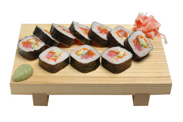Sushi on a wooden stand, wasabi and pickled ginger. On white isolated background