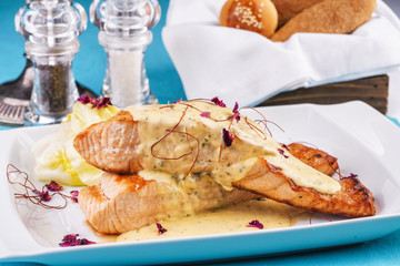 Seafood, Mediterranean cuisine. Sea Salmon Steak fish with greens, cabbage and cheese with cream sauce. Caucasian national cuisine