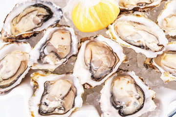 Mediterranean dish, European cuisine. Fresh raw mussels served with lemon, and assorted sauces- oyster, soy, creamy, mustard, red chili pepper sauce