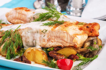 Seafood, Mediterranean cuisine. Grilled salmon fish steak with grilled vegetables and oyster mushrooms. Caucasian kitchen