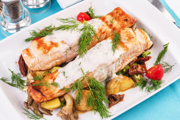 Seafood, Mediterranean cuisine. Grilled salmon fish steak with grilled vegetables and oyster mushrooms. Caucasian kitchen