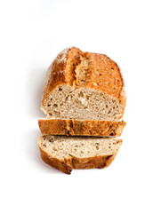 Loaf of whole wheat bread with slices isolated on white background