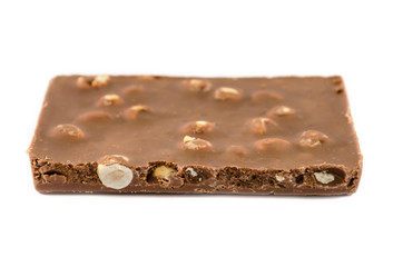 milk chocolate with nuts on a white background, closeup