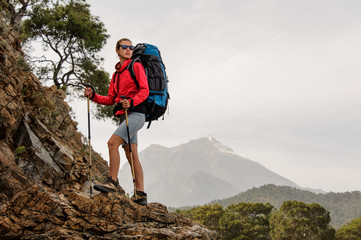 Female traveller trekking on hills on coast