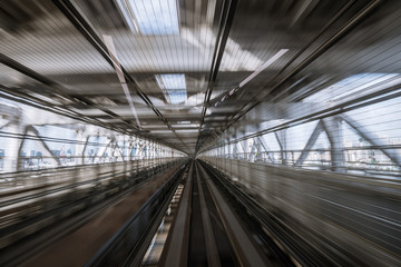 motion-blurred view from a moving train running in tunnel