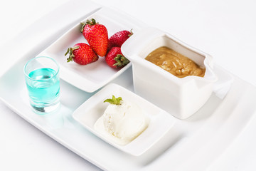 vanilla ice cream fondue, milk chocolate, and strawberries on skewers