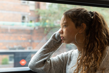Young girl travels by bus in London