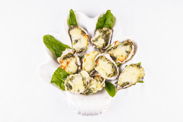 Mediterranean dish, European cuisine. baked mussels under creamy cheese crust with greens