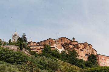 Fototapeta premium Medieval buildings on hilltop in Siena, Italy. 