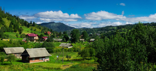 Panorama with green forest and village. Village Slavske, Ukraine