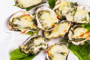 Mediterranean dish, European cuisine. baked mussels under creamy cheese crust with greens