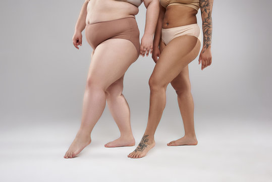 Couple of fat female friends in underwear walking Stock Photo