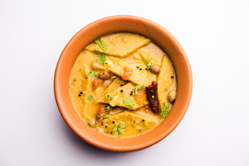 Dal Dhokli, Varan Phal or Chakolya is a gujarati, Rajasthani and maharashtrian dish made using diamond shape wheat flour cakes boiled in a dal. It's an easy one pot meal. served in a bowl.
