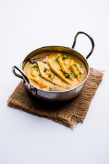 Dal Dhokli, Varan Phal or Chakolya is a gujarati, Rajasthani and maharashtrian dish made using diamond shape wheat flour cakes boiled in a dal. It's an easy one pot meal. served in a bowl.