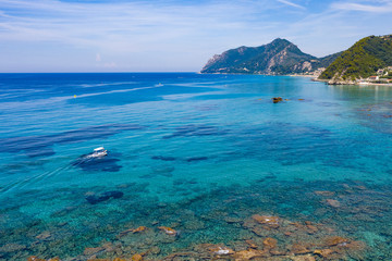 Aerial view of green mountains in the sea and costline.