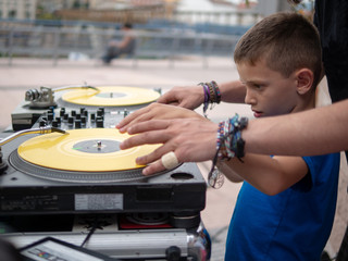  boy learning to mix record on turntable