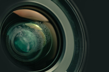 Close up fingerprint on a camera lens background. Macro view.