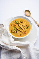 Dal Dhokli, Varan Phal or Chakolya is a gujarati, Rajasthani and maharashtrian dish made using diamond shape wheat flour cakes boiled in a dal. It's an easy one pot meal. served in a bowl.