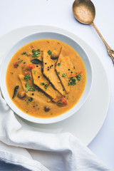 Dal Dhokli, Varan Phal or Chakolya is a gujarati, Rajasthani and maharashtrian dish made using diamond shape wheat flour cakes boiled in a dal. It's an easy one pot meal. served in a bowl.