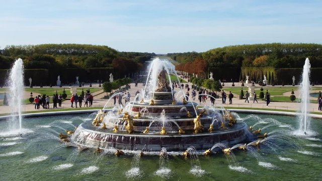 People at Versailles palace, fountains and gardens in France