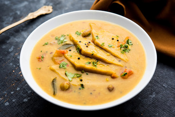 Dal Dhokli, Varan Phal or Chakolya is a gujarati, Rajasthani and maharashtrian dish made using diamond shape wheat flour cakes boiled in a dal. It's an easy one pot meal. served in a bowl.