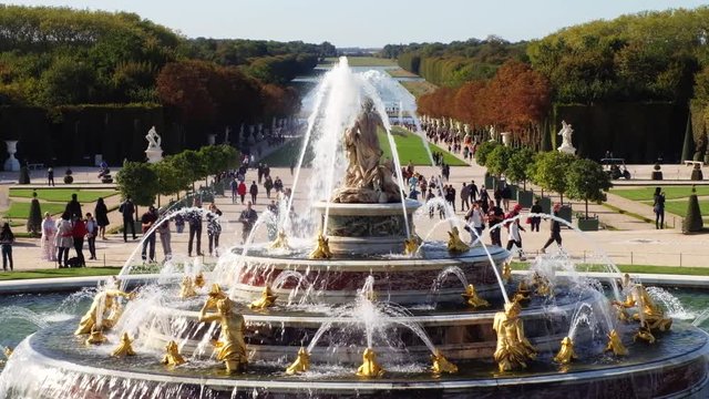 People at Versailles palace, fountains and gardens in France