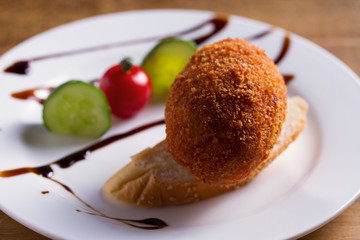Chicken Kiev and vegetables. Breaded chicken breast stuffed with herbs and butter