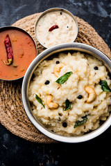 Ven pongal recipe is a popular South Indian food prepared with rice & moong dal and served with sambar and coconut chutney, selective focus