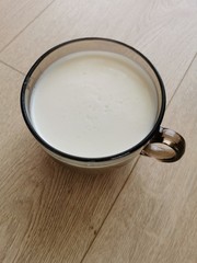 cup of milk on wooden table