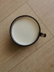 cup of milk on wooden table