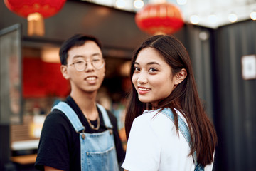 Asian couple staying together on street cafe view