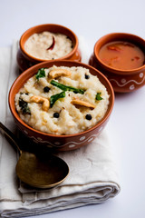 Ven pongal recipe is a popular South Indian food prepared with rice & moong dal and served with sambar and coconut chutney, selective focus