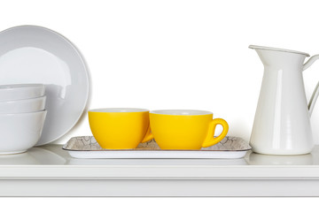 Kitchen dishes on a shelf isolated on white background