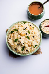 Ven pongal recipe is a popular South Indian food prepared with rice & moong dal and served with sambar and coconut chutney, selective focus