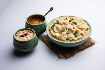 Ven pongal recipe is a popular South Indian food prepared with rice & moong dal and served with sambar and coconut chutney, selective focus
