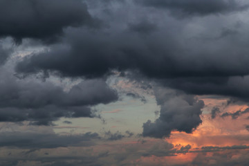 Naklejka na ściany i meble Stormy skies at sunset. Dark dramatic storm clouds