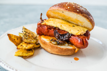 Hot Dog Sandwich Bratwurst Sausage with Baked Spicy Potatoes.