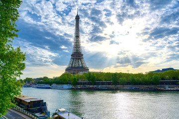 Naklejka na ściany i meble The Eiffel Tower across the Seine River in Paris, France on a sunny day with beautiful clouds.